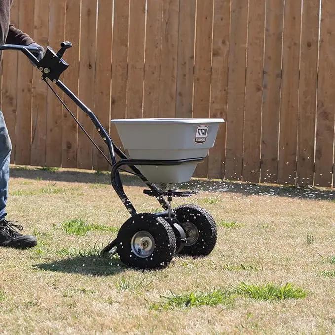 Titan Attachments 70 LB Professional Fertilizer Push Broadcast Spreader, Spreads 10 to 12 FT, Lawn Care and Ice Melter, Yard Tool by GreenHaven Gardens
