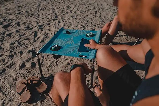 Neso Portable Beach Table with Cup Holders, Cell Phone Pockets, Lightweight for Picnics and Parks (Aqua Fronds) by GreenHaven Gardens