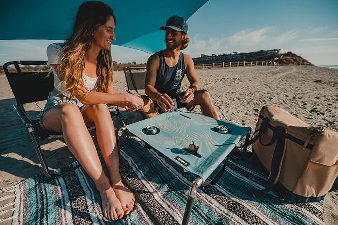 Neso Portable Beach Table with Cup Holders, Cell Phone Pockets, Lightweight for Picnics and Parks (Aqua Fronds) by GreenHaven Gardens