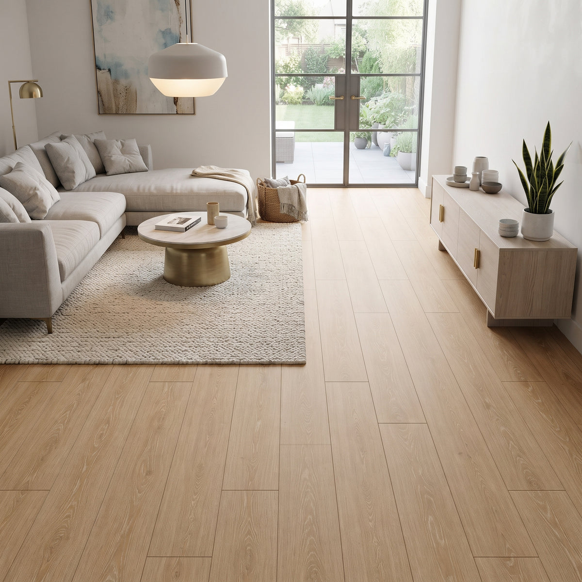 Light oak wood plank flooring shown in a modern, bright living room with a beige sectional sofa, white rug, and large windows.