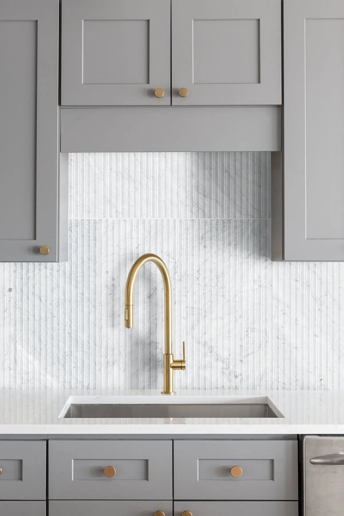 Carrara White Valentino Fluto 12x24 Honed Marble Mosaics in a finished room