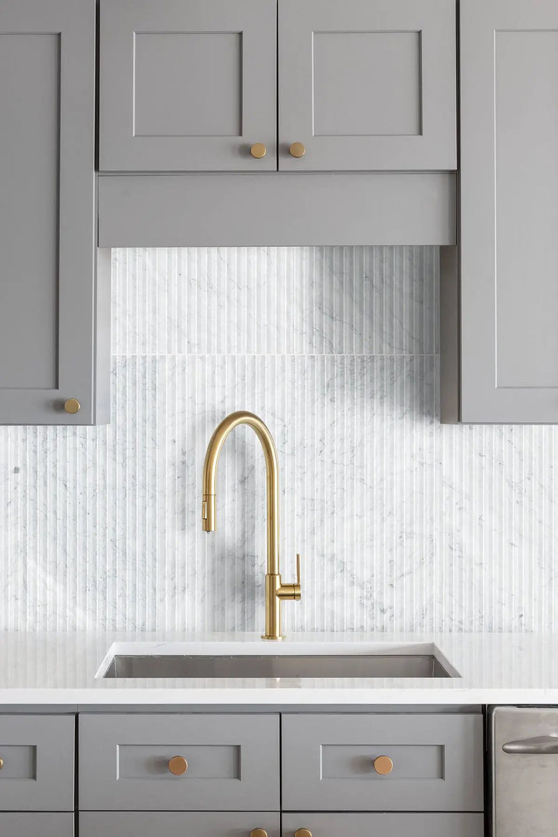 Carrara White Valentino Fluto 12x24 Honed Marble Mosaics in a finished room