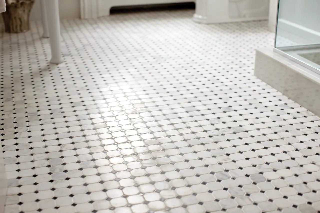 Greecian White 2" Octagon With Black 5/8x5/8 Polished In 12x12 Mesh Marble Mosaics in a finished room