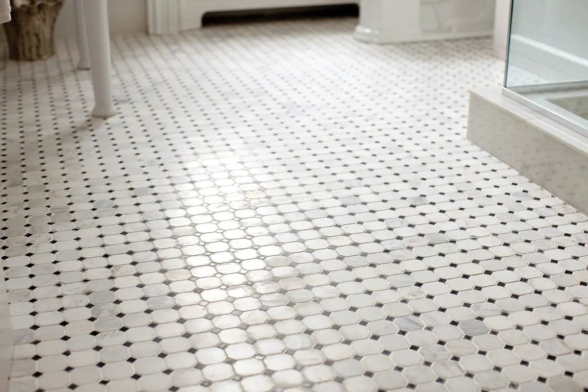 Greecian White 2" Octagon With Black 5/8x5/8 Polished In 12x12 Mesh Marble Mosaics in a finished room