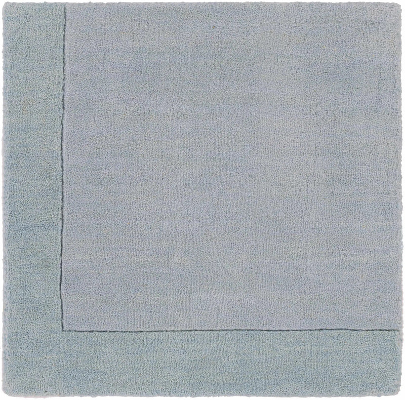 Arkabutla Solid Blue Bordered Wool Rug by Boutique Rugs