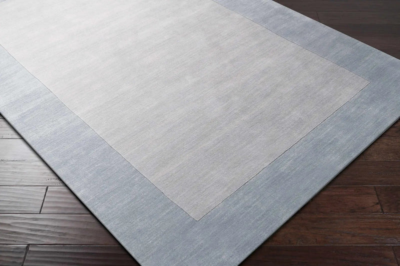 Arkabutla Solid Blue Bordered Wool Rug by Boutique Rugs