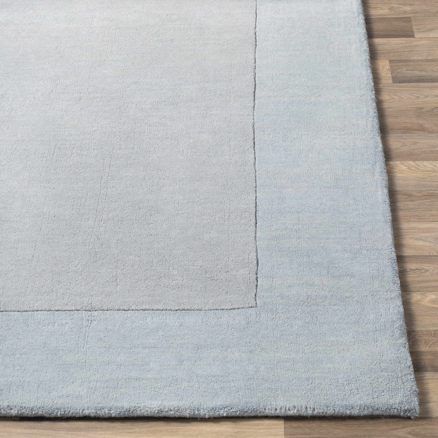 Arkabutla Solid Blue Bordered Wool Rug by Boutique Rugs