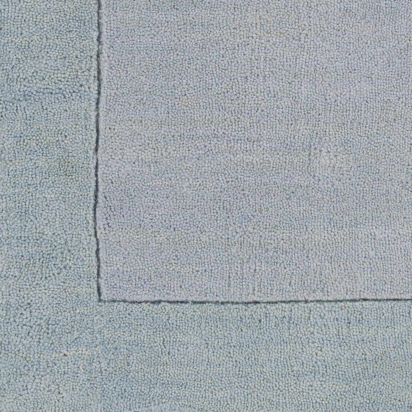Arkabutla Solid Blue Bordered Wool Rug by Boutique Rugs