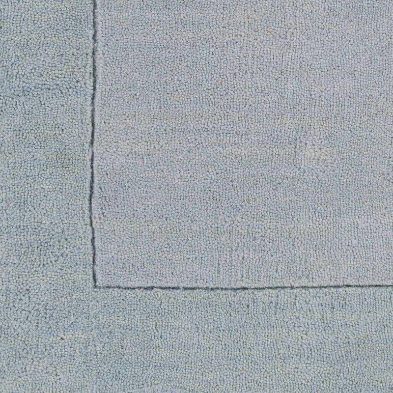 Arkabutla Solid Blue Bordered Wool Rug by Boutique Rugs