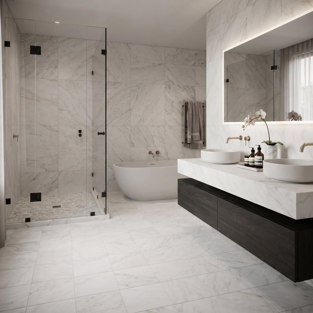 A modern luxury bathroom featuring a large walk-in shower with a glass door, a freestanding bathtub, a double-sink vanity with a long dark wood cabinet and white marble countertop, and a large backlit mirror.