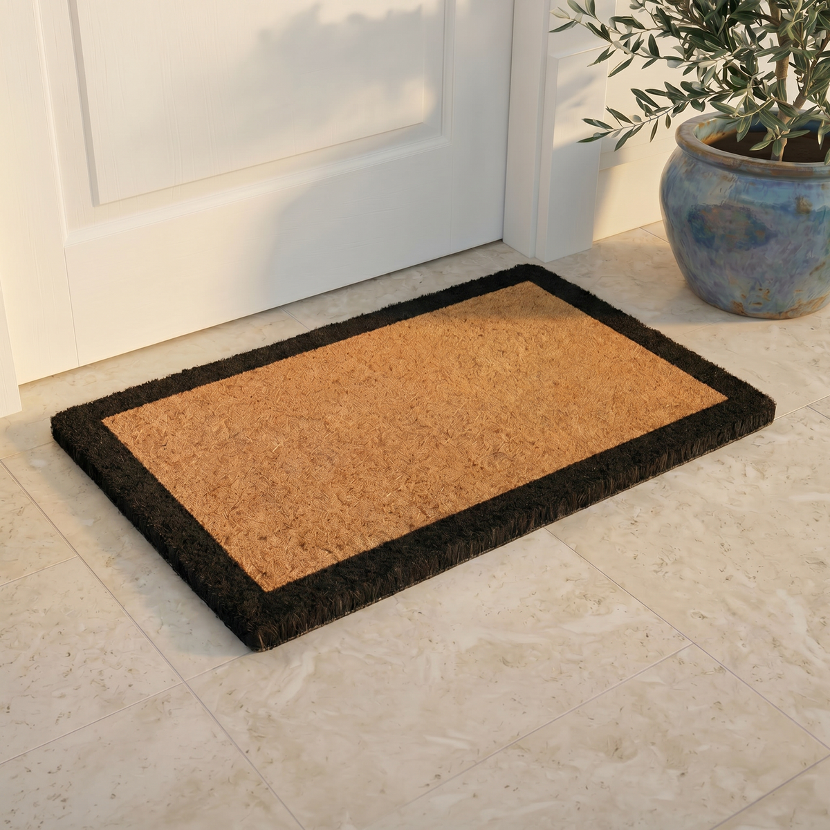Black Border Coir Doormat, installed in a room