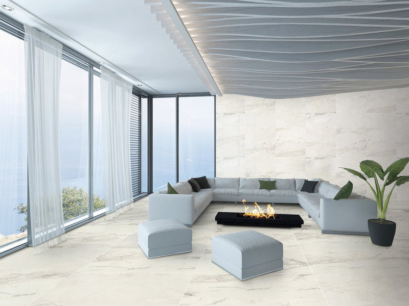 Carrara Select 2.0 Calacatta Renoire Honed Marble Look Cove Base Porcelain Trim 6x12 installed in a living room