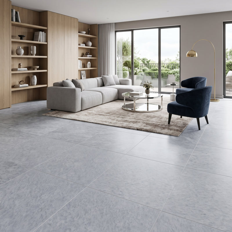 Modern living room featuring large-format Diamond Blue honed marble floor tiles in soft gray-blue tones with natural veining.