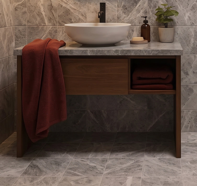 Grey marble bathroom tiles with a wood vanity and stone vessel sink