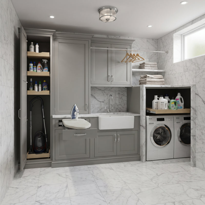 A modern laundry room featuring gray cabinets, a white farmhouse sink, a built-in ironing station with a hanging vacuum, and a washer/dryer stack on a marble-tiled floor.