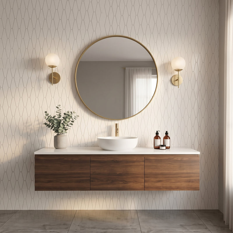 A modern floating bathroom vanity with a white vessel sink, gold faucet, round gold-framed mirror, and two wall sconces against patterned wallpaper.