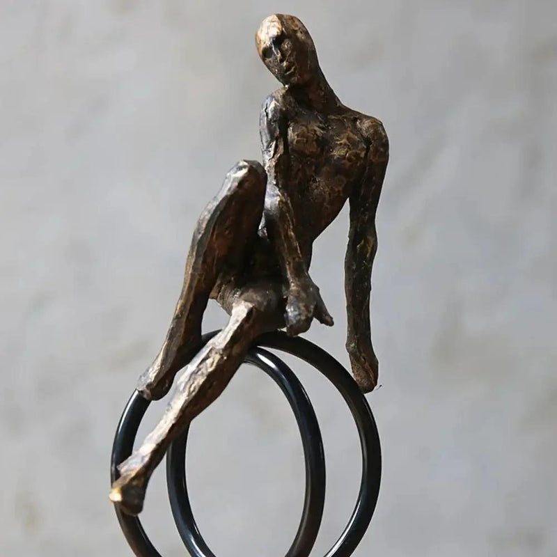 Abstract Seated Figure Sculpture on Geometric Stand – Modern Iron Table Decor by House Of Avana