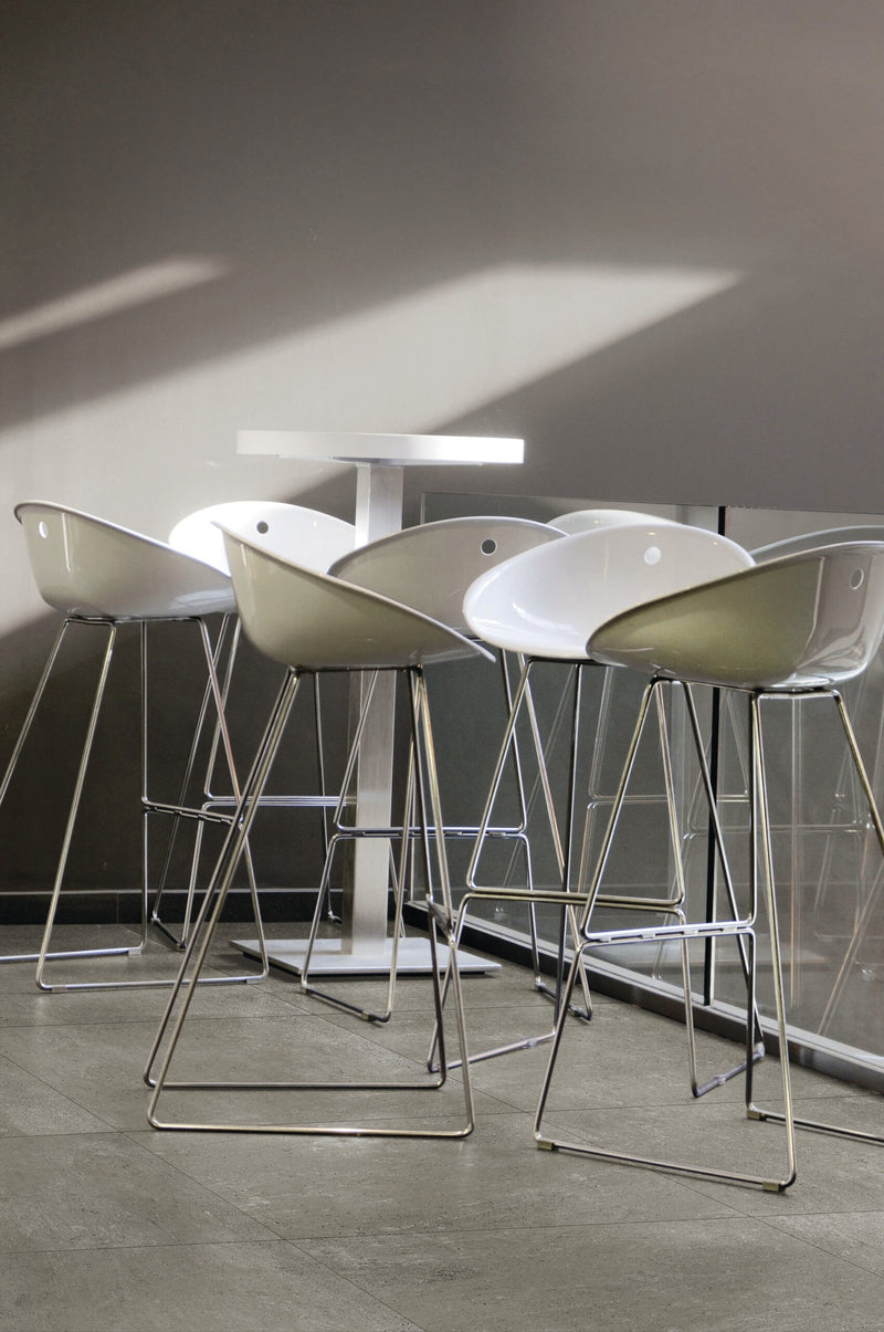 Simply Modern Grey Honed Concrete Look Porcelain Tiles 12x24 installed in a cafe