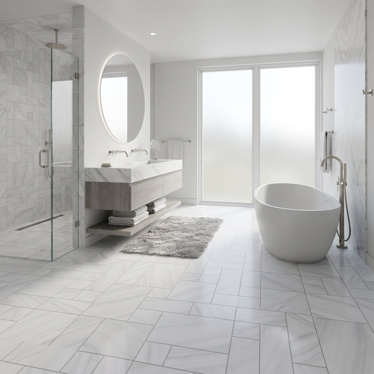 A modern bathroom interior with a freestanding oval bathtub, a floating double-sink vanity with a large round mirror, a glass shower enclosure, and light marble-look floor and wall tiles.