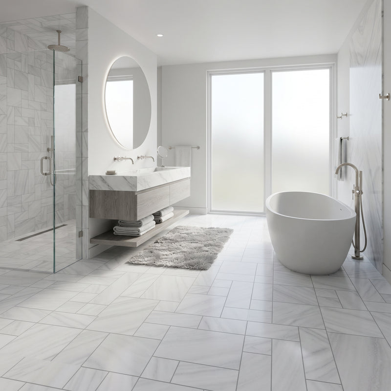 A modern bathroom interior with a freestanding oval bathtub, a floating double-sink vanity with a large round mirror, a glass shower enclosure, and light marble-look floor and wall tiles.