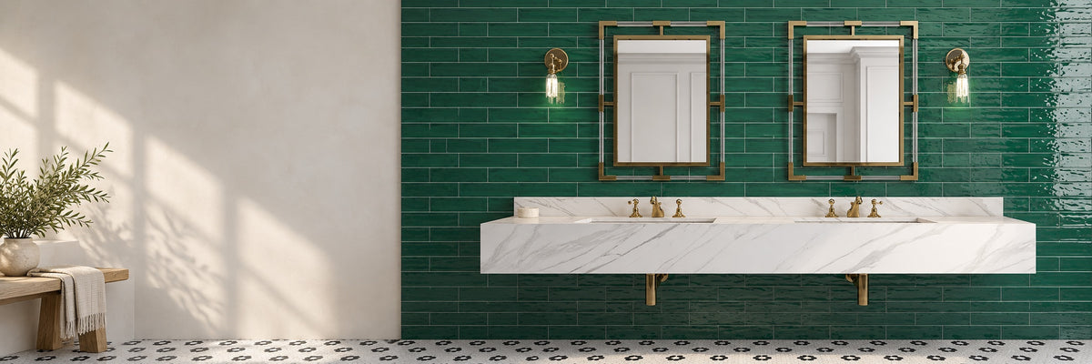 Double marble vanity against a glossy green subway tile wall