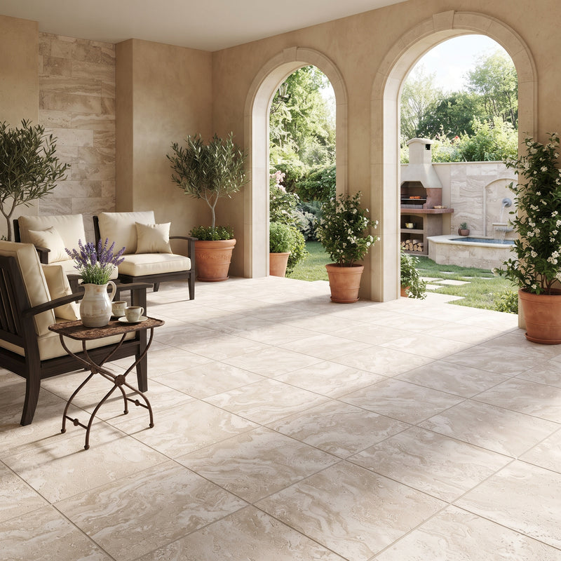 Large beige stone-look floor tiles installed in a luxurious outdoor patio with arches, furnished seating, and potted plants.