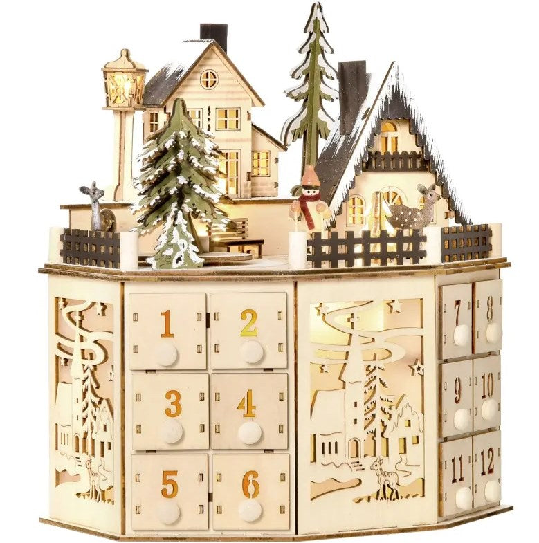 Wooden Christmas Advent Calendar with Village Scene and 24 Drawers, Natural, installed in a room